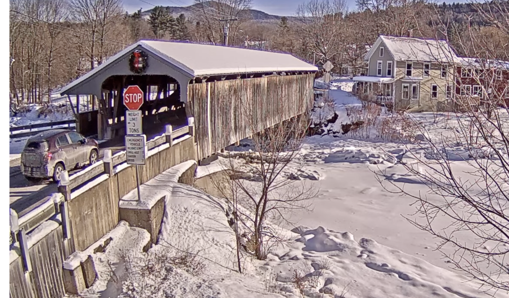A car prepares to enter a covered bridge